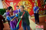 志愿者教授老人筷子舞基本动作。　刘文华 摄 - Nmgcb.Com.Cn